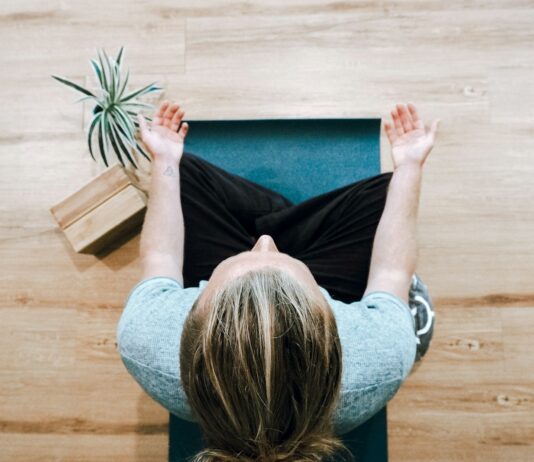 스트레스를 줄이고 건강을 지키는 일상 루틴 woman in black shirt and gray pants sitting on brown wooden bench