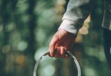 “작은 변화가 만드는 큰 차이, 일상 속 스트레스 관리법” a person holding a pair of headphones in their hand